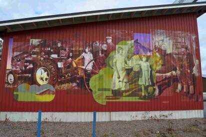 Muralmålning med gamla foton som förlaga. Motivet är en traktor och människor med en häst.